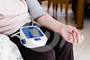 Measuring the blood pressure of a senior woman