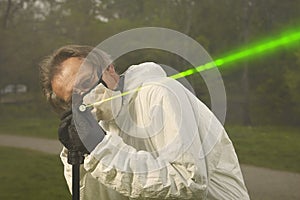 Measuring of bullet trajectory with ballistics trajectory laser and smoke on crime scene photo