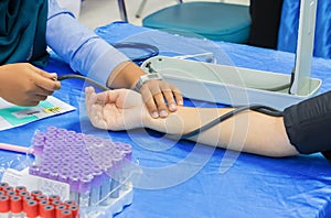 Measuring checking health blood pressure arm of patient on table fabric blue