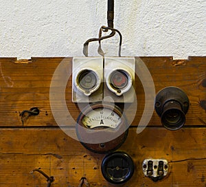 Measuring device socket and fuse on wooden panel