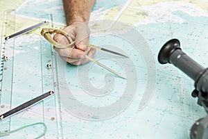 Measuring distance on a sea chart tool. Close-up. Navigation in the maritime industry and yachting