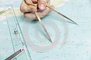 Measuring distance on a sea chart tool. Close-up. Navigation in the maritime industry and yachting