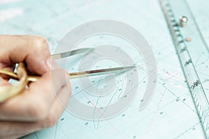 Measuring distance on a sea chart tool. Close-up. Navigation in the maritime industry and yachting