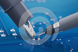 Measuring electronic signal using oscilloscope on the PCB. Electronics repair and digital technology