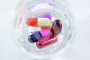 Measuring glass with capsules and tablets