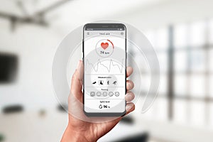 Measuring heart rate app on smart phone in hand. Concept of measuring in office