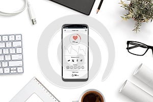 Measuring heart rate, beats per minute app on modern smart phone on office desk