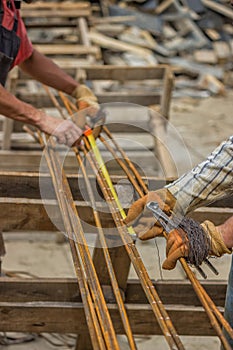 Measuring and marking steel rods for making beam cages 2