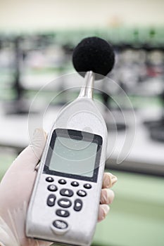 Measuring the noise in laboratory room with a sound level meter.