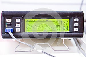 Measuring Oxygen blood saturation device and Pulse Oximeter display for patient in a hospital.