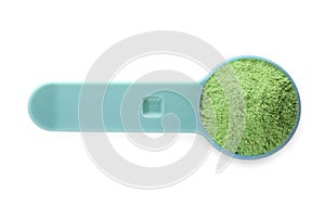 Measuring scoop with wheat grass powder on white background