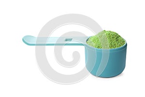 Measuring scoop with wheat grass  on white background