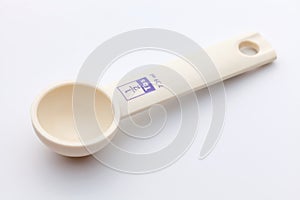 Measuring spoon on white background
