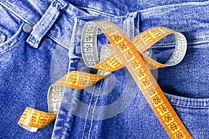 Measuring tape against the backdrop of jeans