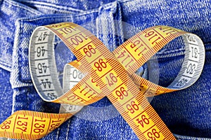 Measuring tape against the backdrop of jeans