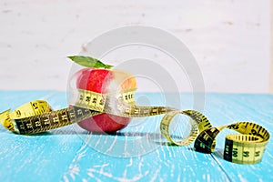 Measuring tape around an apple. Diet and weight loss concept