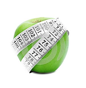 Measuring tape around green apple