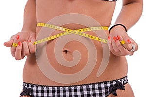 Measuring tape around woman's waist