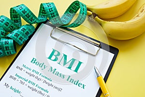 Measuring tape and BMI body mass index formula.