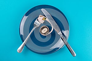 Measuring tape on a fork and knife - dieting concept image