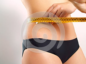 Measuring tape on a woman's waist