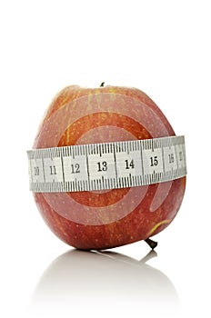 Measuring tape wrapped around apple