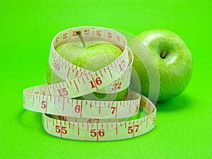 Measuring tape wrapped around apple