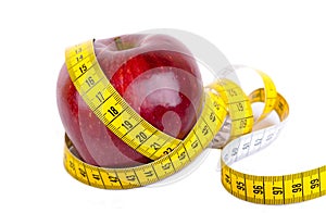 Measuring tape wrapped around a apple weight loss