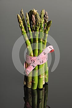 Measuring Tape Wrapped Around Asparagus photo