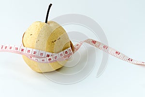 Measuring tape wrapped around a Chinese pear