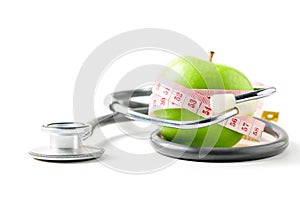 Measuring tape wrapped around a green apple with  stethoscope isolated