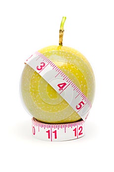 Measuring tape wrapped around a passion fruit