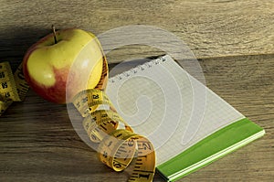 Measuring tape wrapped around a red apple