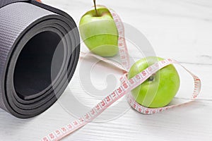Measuring tape wrapped around two green apple isolated on white background, Concept of the goal to lose weight,the goal