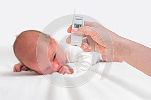Measuring temperature to a newborn baby with digital thermometer