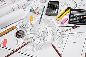 Measuring tools on the background of technical drawings.