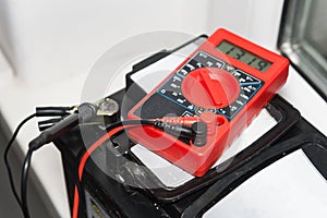 Measuring voltage with a multimeter and repairing electrical equipment