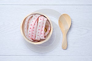 Measuring waist in wooden bowl