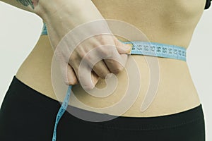 Measuring womans waist in the gym