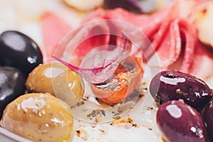 Meat appetizer selection. Salami, prosciutto, bread sticks, baguette, olives and sun-dried tomatoes, selective focus.