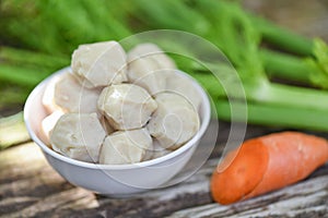Meat ball on bowl and vegetable on wooden background, meat ball with pork and ingredient for cooked asian thai food