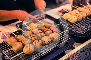 Meat ball stick cooking on electric grill oven.