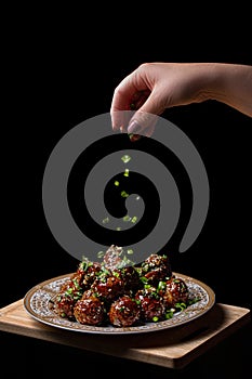 Meat balls with quail egg inside, on a black background