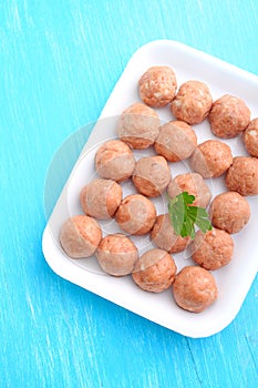 Meat balls from raw minced meat in a white tray