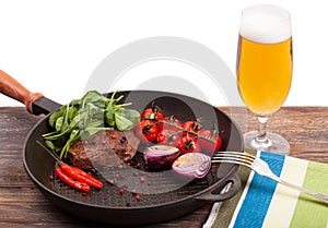 Meat, beer and vegetables in frying pan isolation