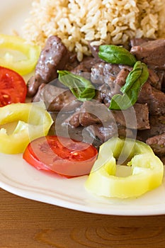 Meat with brown rice and garnish