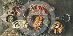 Meat, cheese, olives, sandwiches, prosciutto, buns on wooden background