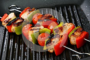 Meat, cherry tomato and red and green pepper skewe