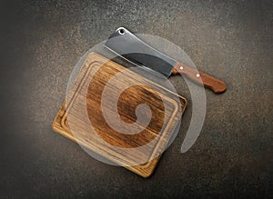 Meat cleaver and chopping board on table