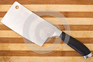 Meat cleaver isolated over wooden background